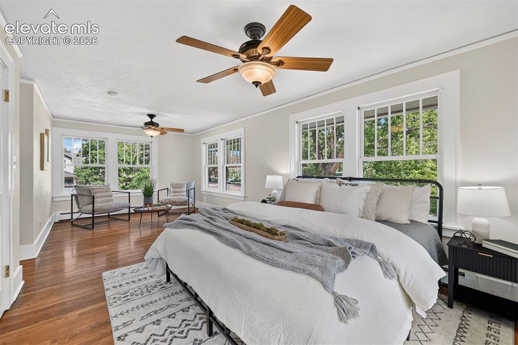 Image 6 of 36: Large Primary suite spans the width of the house with windows on 3 sides.