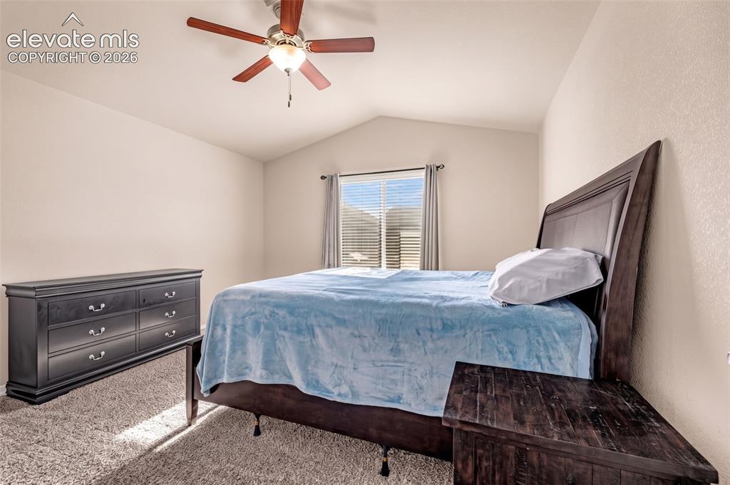 Image 17 of 45: Vaulted ceiling with a ceiling fan, window with blinds, and neutral-toned w