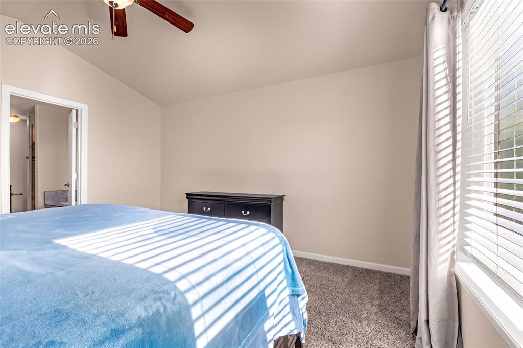 Image 18 of 45: Carpeted room with a ceiling fan, recessed window, and neutral wall tones