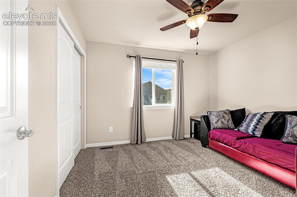 Image 25 of 45: Neutral wall paint, carpet flooring, a ceiling fan with integrated lighting
