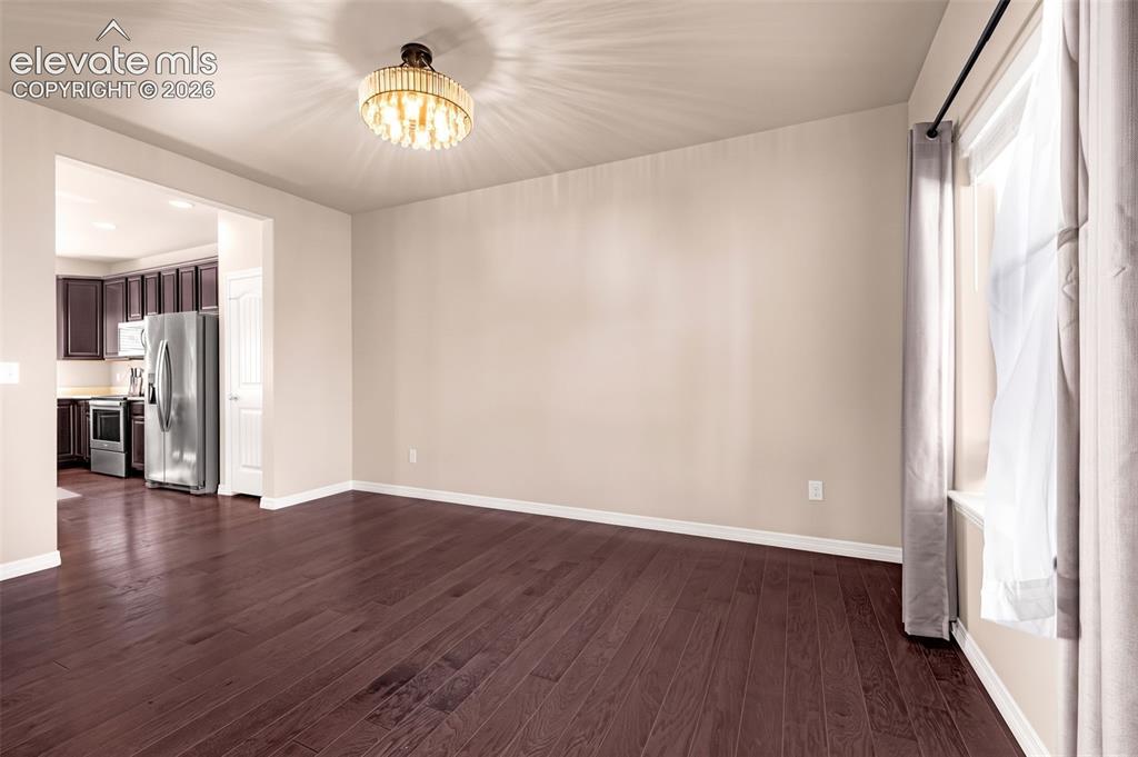 Image 6 of 45: Wood-finish flooring throughout, with a decorative ceiling light fixture