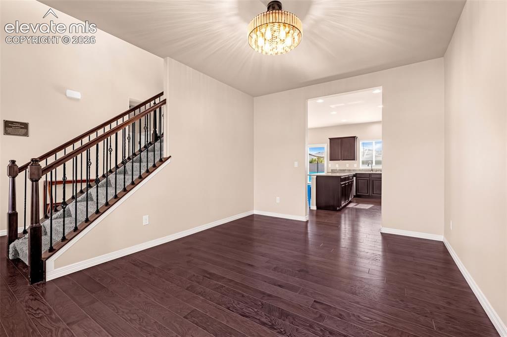 Image 7 of 45: Dark wood-finish flooring with light-toned walls