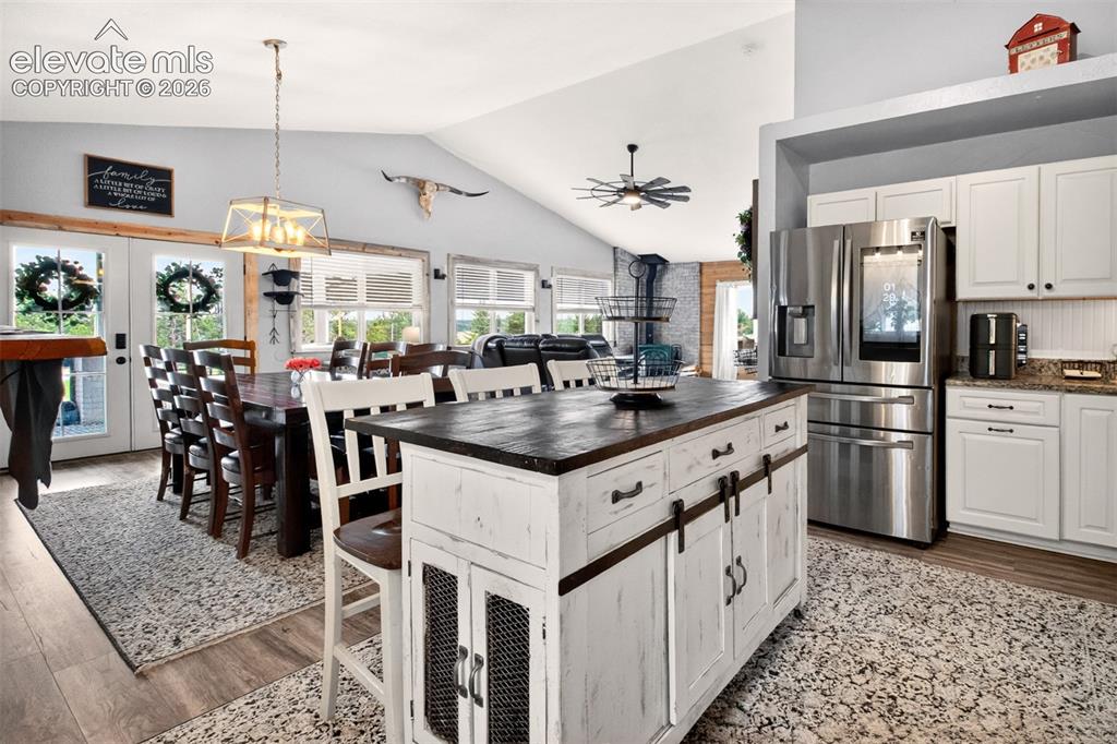 Image 12 of 50: Nice open-concept layout with newer LVP flooring, granite counters, and hig