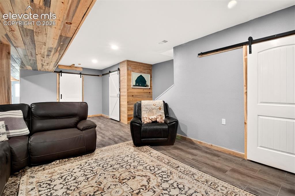 Image 25 of 50: The custom pine accents elevate the entire lower level, creating a warm, so