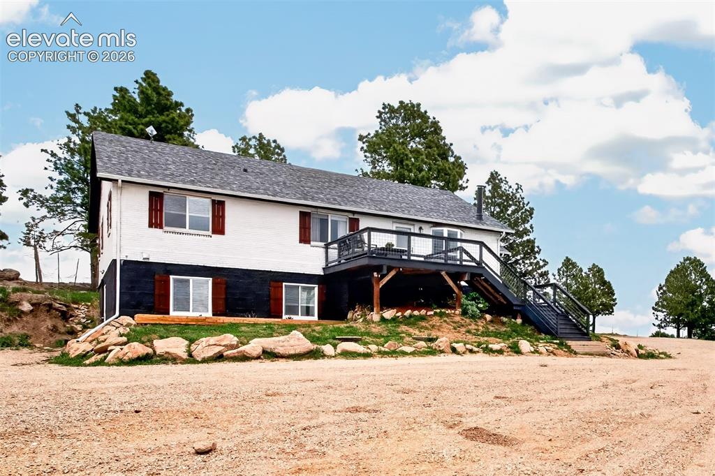 Image 38 of 50: Side Entrance with Large Deck with unobstructed views of Pikes Peak!!!