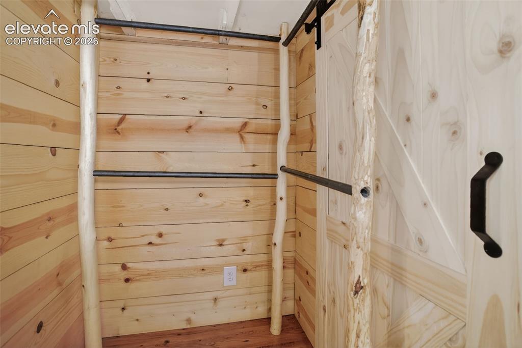 Image 14 of 39: Closet with beautiful wood paneling