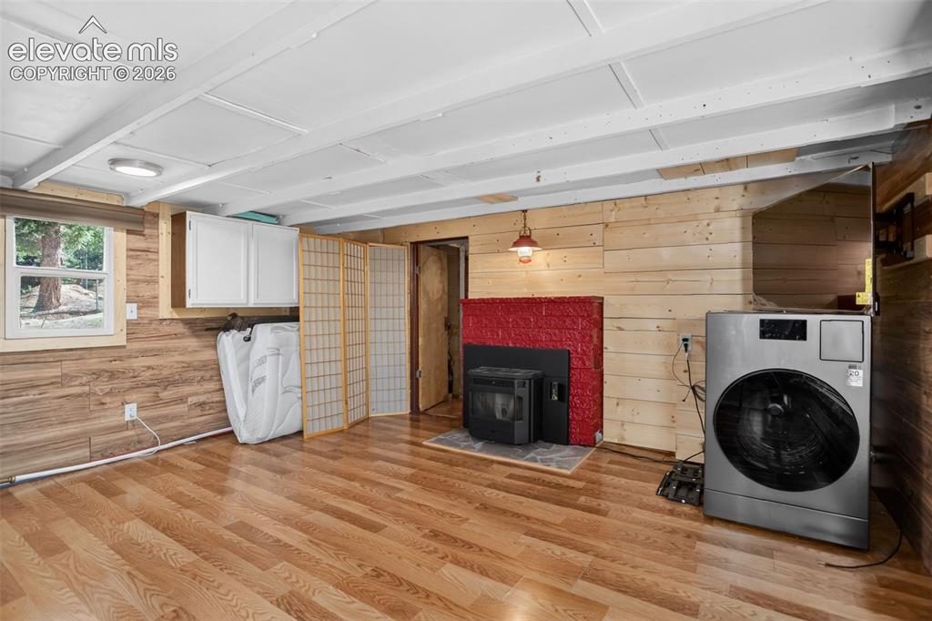Image 7 of 39: Pellet stove heats the entire home. Brand new washer/dryer.