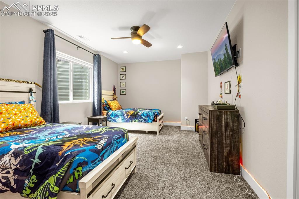 Image 23 of 35: Bedroom with carpet flooring, a ceiling fan, and recessed lighting