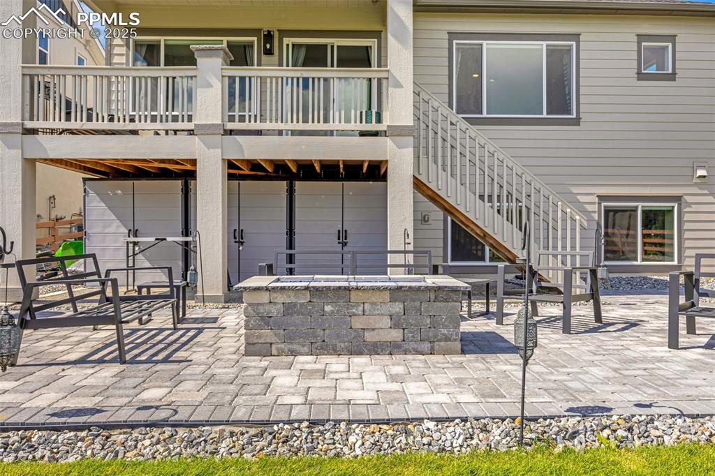 Image 30 of 35: Built in fire pit + storage cabinets
