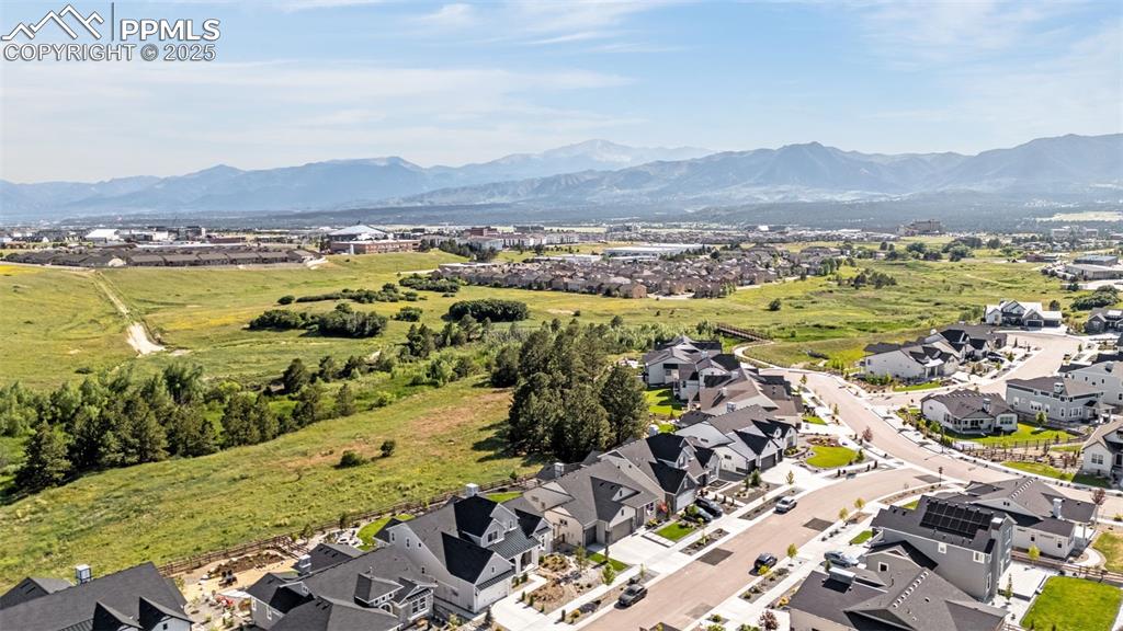 Image 35 of 35: Aerial perspective of suburban area featuring a mountain backdrop