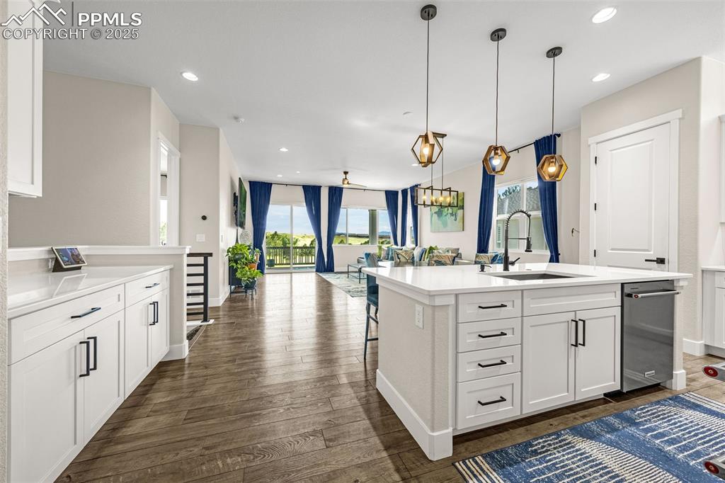 Image 5 of 35: Kitchen featuring open floor plan, dark wood finished floors, light counter