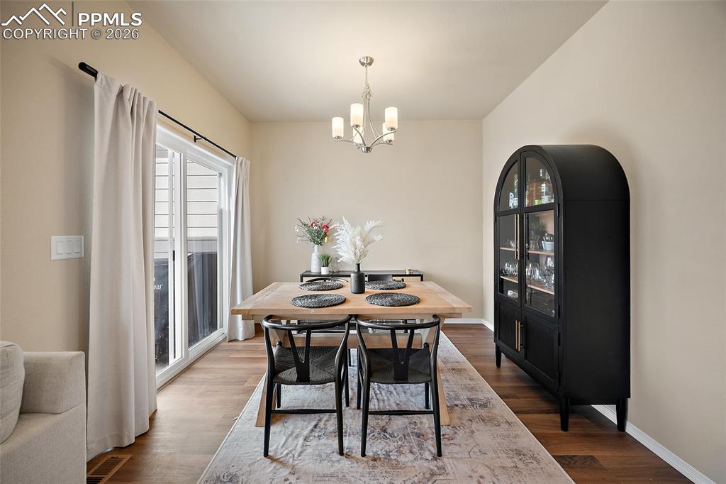 Image 16 of 49: Dining space with doorway to extended outdoor living space