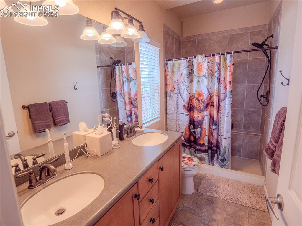 Image 12 of 17: Dual vanity with integrated sinks and bronze-finish faucets
