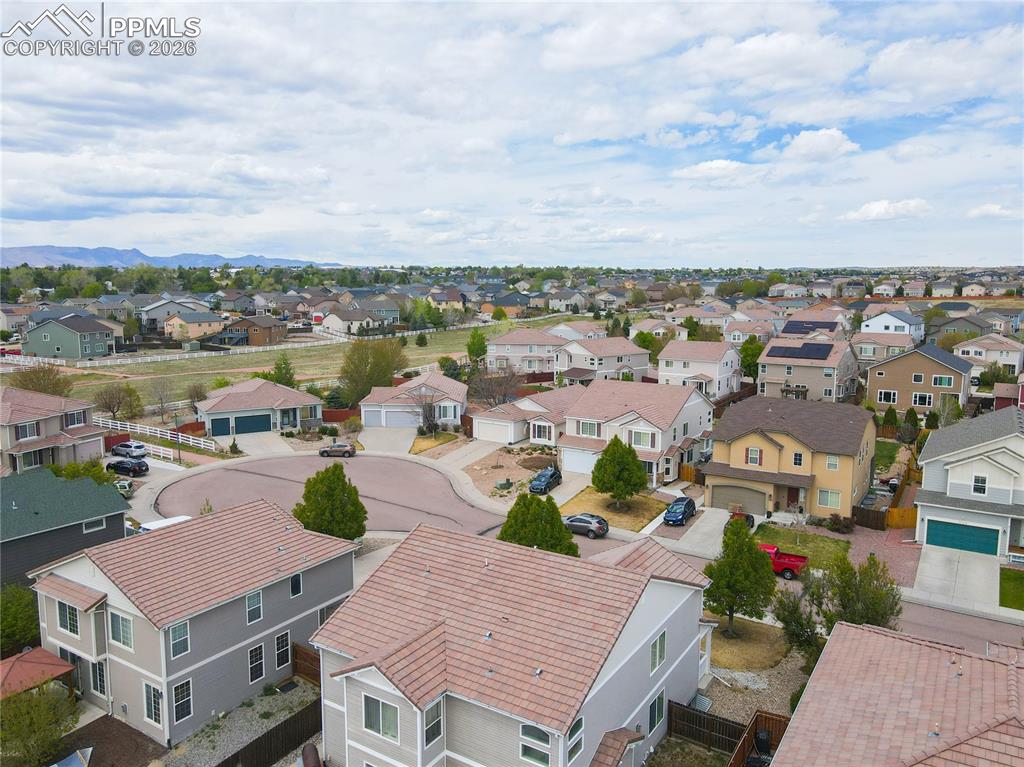 Image 13 of 17: Residential neighborhood featuring a cul-de-sac, mature trees, and mountain