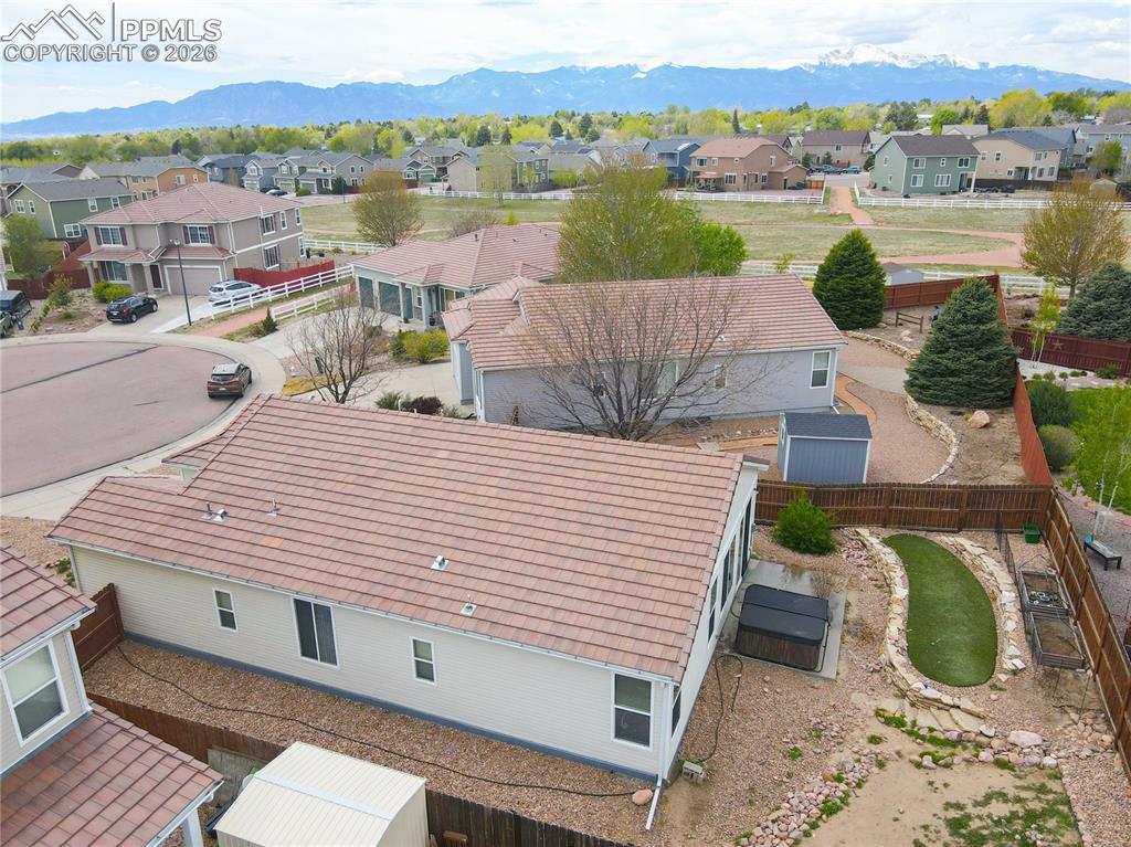 Image 14 of 17: Expansive property featuring a tiled roof, gravel landscaping, a hot tub, a