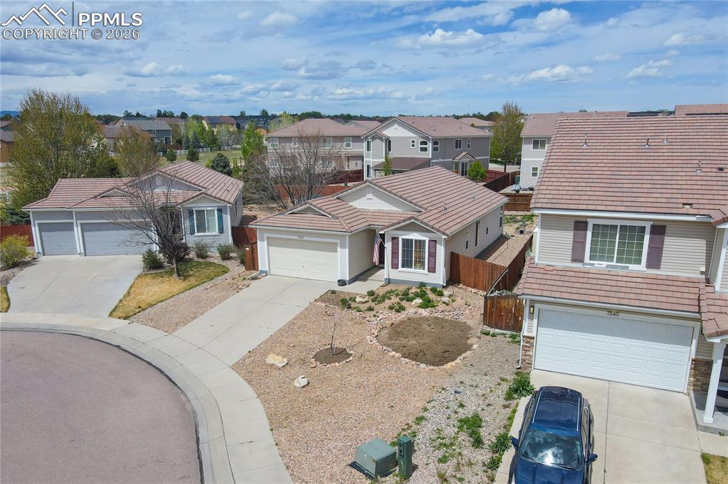 Image 15 of 17: Single-story residence featuring a tile roof, light-toned siding, and a fro