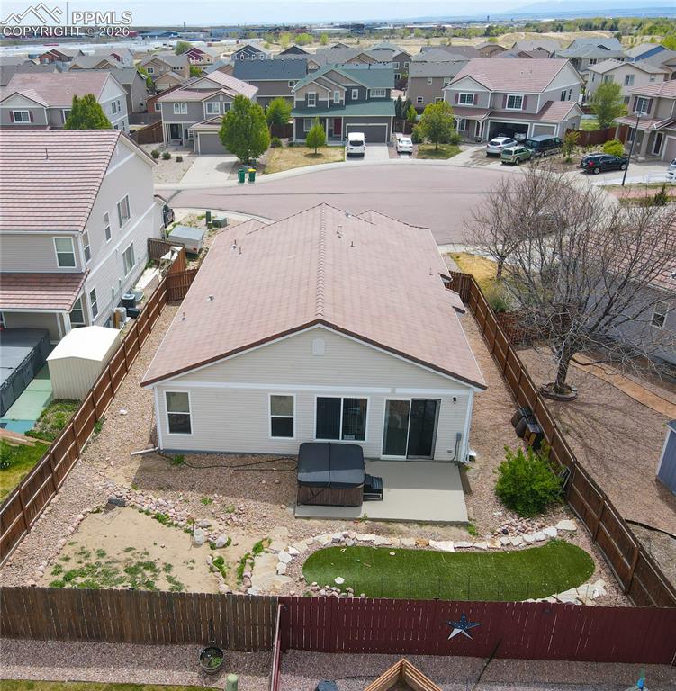 Image 16 of 17: Fenced backyard featuring a concrete patio, artificial turf area, and surro