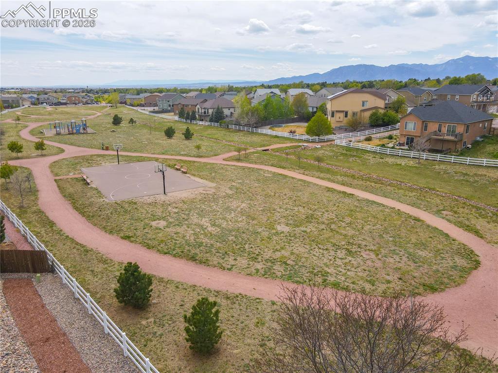 Image 17 of 17: Expansive community park featuring a paved basketball court, mulched walkin