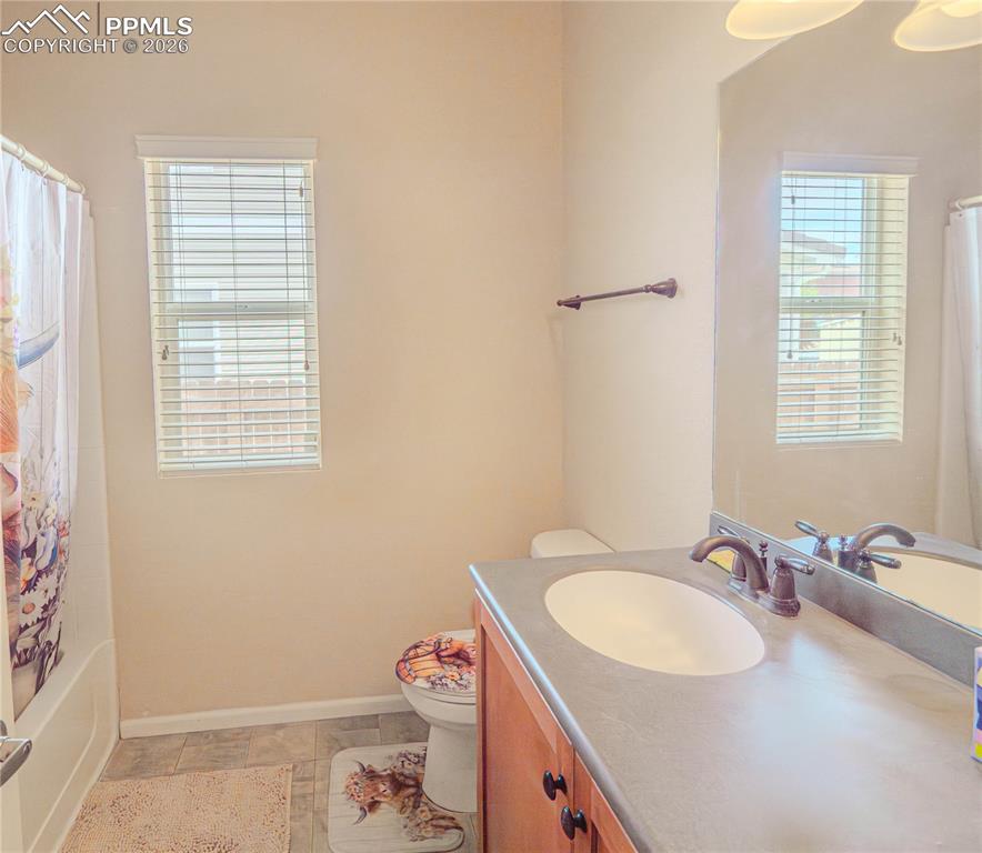 Image 5 of 17: Bathroom featuring a single vanity with wood cabinetry, a surface-mounted s