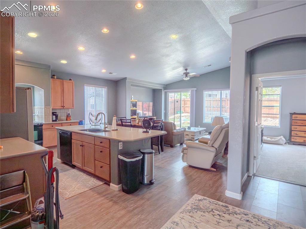 Image 6 of 17: Kitchen with light wood cabinetry, a central island featuring an integrated