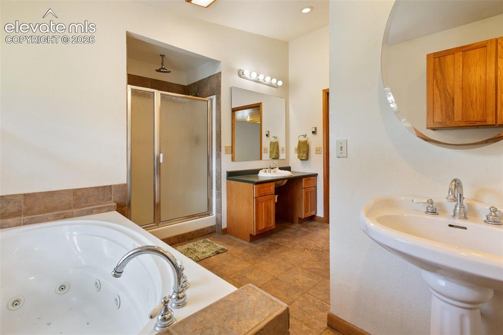 Image 22 of 42: Warm and inviting, the family room showcases a log staircase, classic pot-b