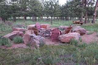 Image 33 of 36: View of yard featuring an outdoor fire pit