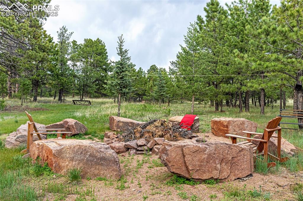 Image 34 of 36: Firepit with solar cafe lights
