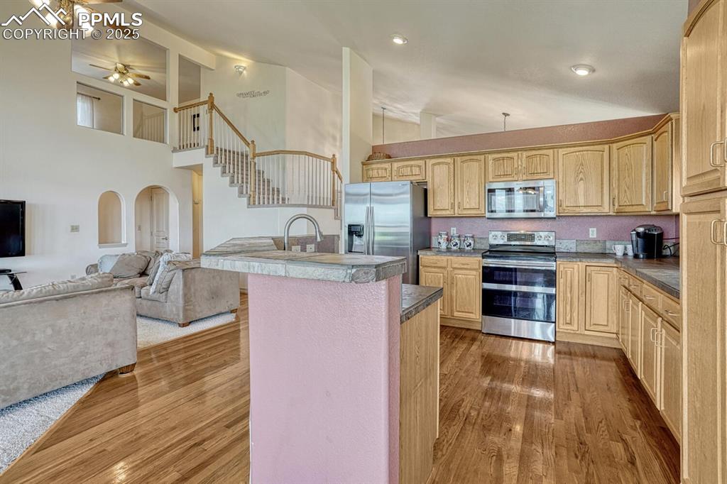 Image 15 of 50: Stainless steel appliances include a gas range, built-in microwave, dishwa