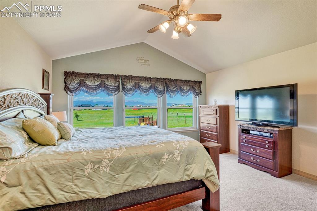 Image 24 of 50: The main-level primary suite is a serene escape with breathtaking mountain