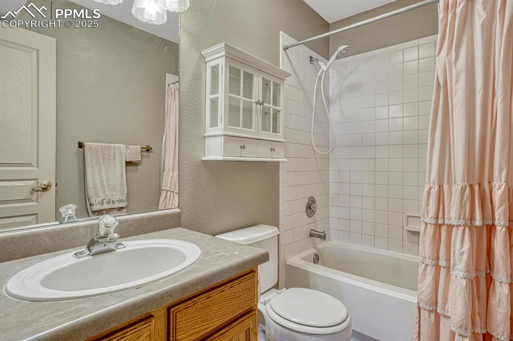 Image 31 of 50: Upper Level Full Bathroom with vanity, mirror, and tiled tub/shower.