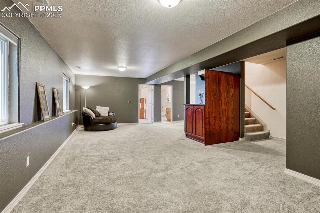 Image 43 of 50: Garden Level Recreation Room with neutral carpet.