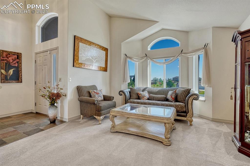 Image 6 of 50: View of front entry and living room.