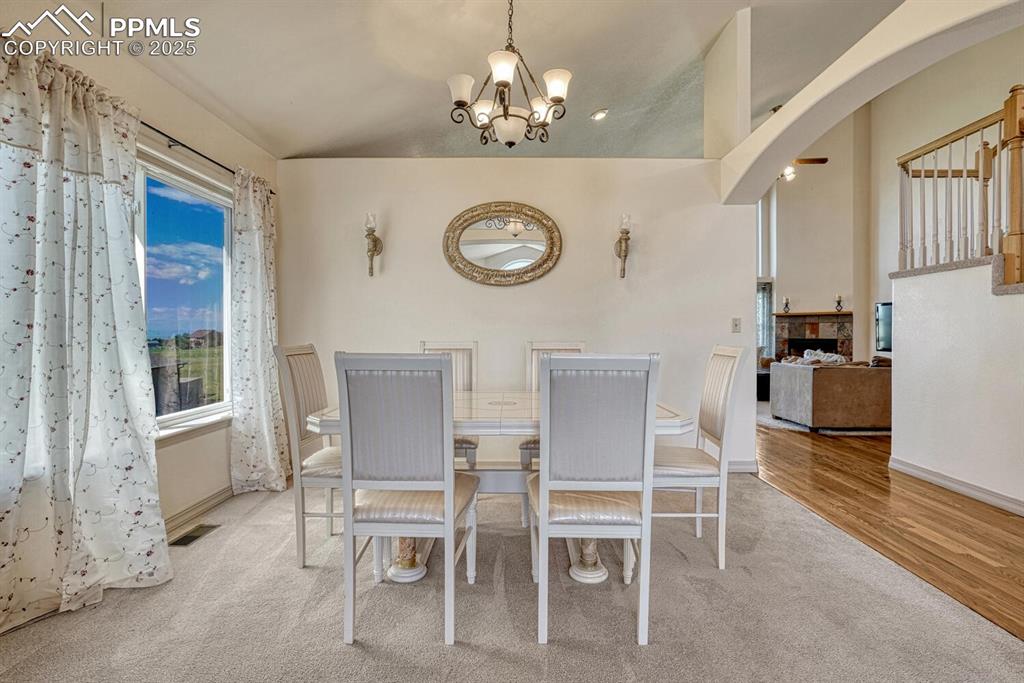 Image 8 of 50: Formal dining toom with large view window that floods the room with natural