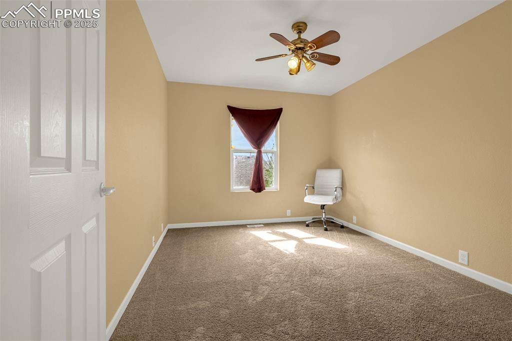 Image 11 of 23: Spare room featuring carpet, ceiling fan, and baseboards