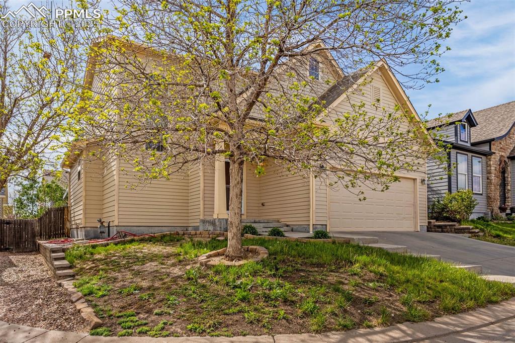 Image 2 of 23: View of front of home featuring driveway and a garage