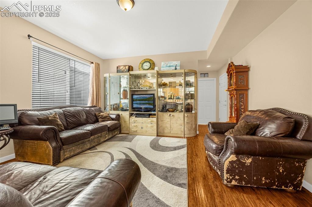 Image 3 of 23: Living area featuring wood finished floors and baseboards