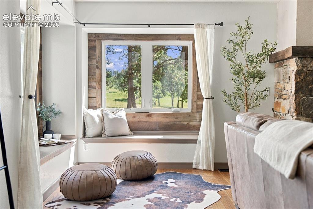Image 10 of 37: Window seat with wood-finish trim and accent wall