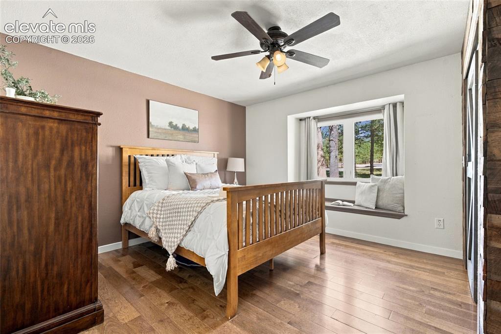 Image 15 of 37: Bedroom with ensuite bathroom, Hardwood flooring, ceiling fan with integrat