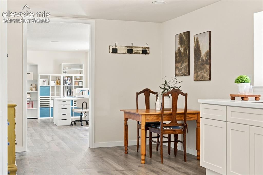 Image 22 of 37: Basement Light-toned walls complement wood-finish flooring throughout