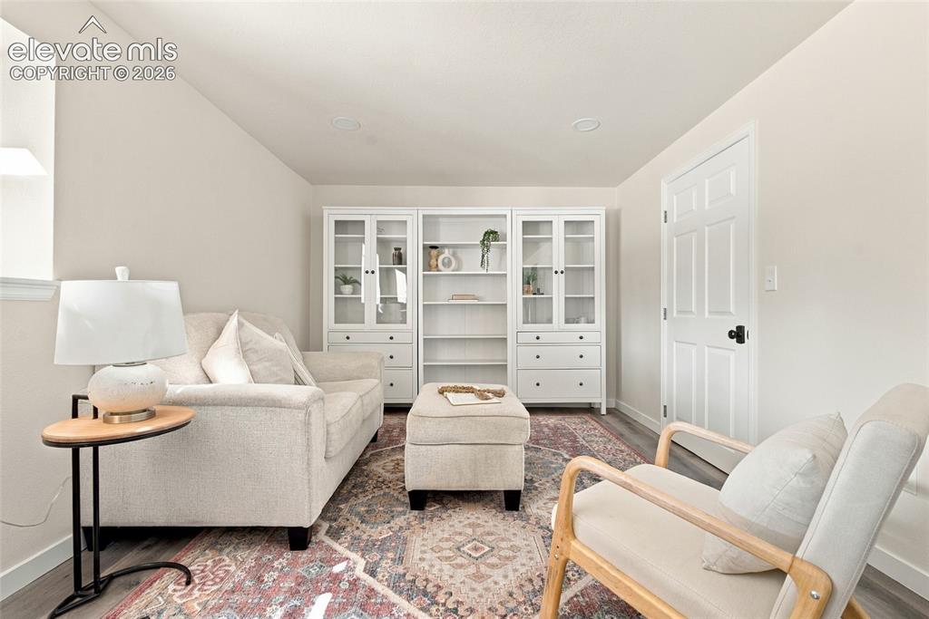 Image 24 of 37: Basement second living area with recessed lighting, wood-finish flooring, b