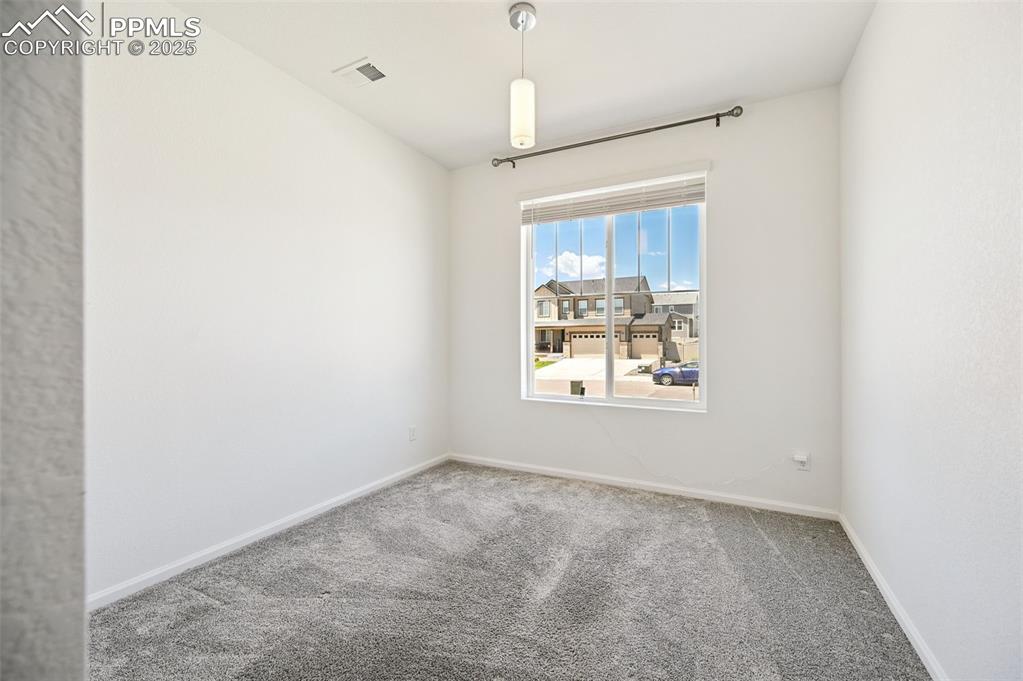 Image 11 of 24: Carpeted empty room featuring baseboards