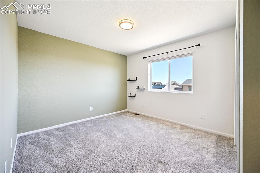 Image 13 of 24: Carpeted empty room with baseboards