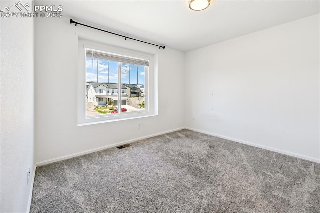 Image 15 of 24: Carpeted spare room with baseboards