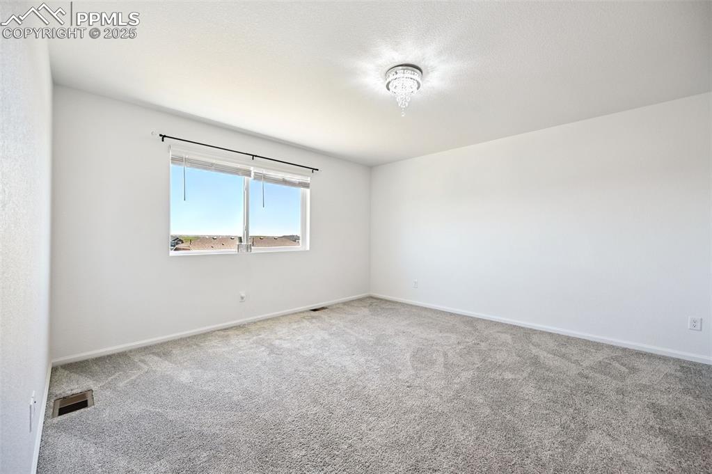 Image 19 of 24: Spare room featuring carpet floors and baseboards
