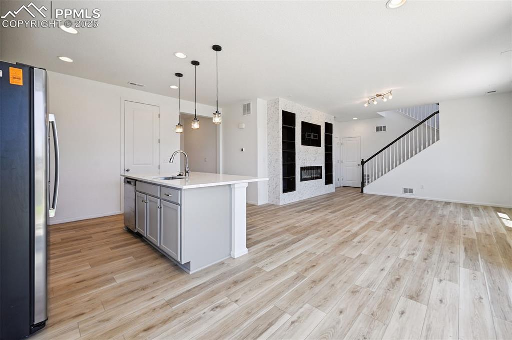 Image 7 of 24: Kitchen featuring appliances with stainless steel finishes, open floor plan