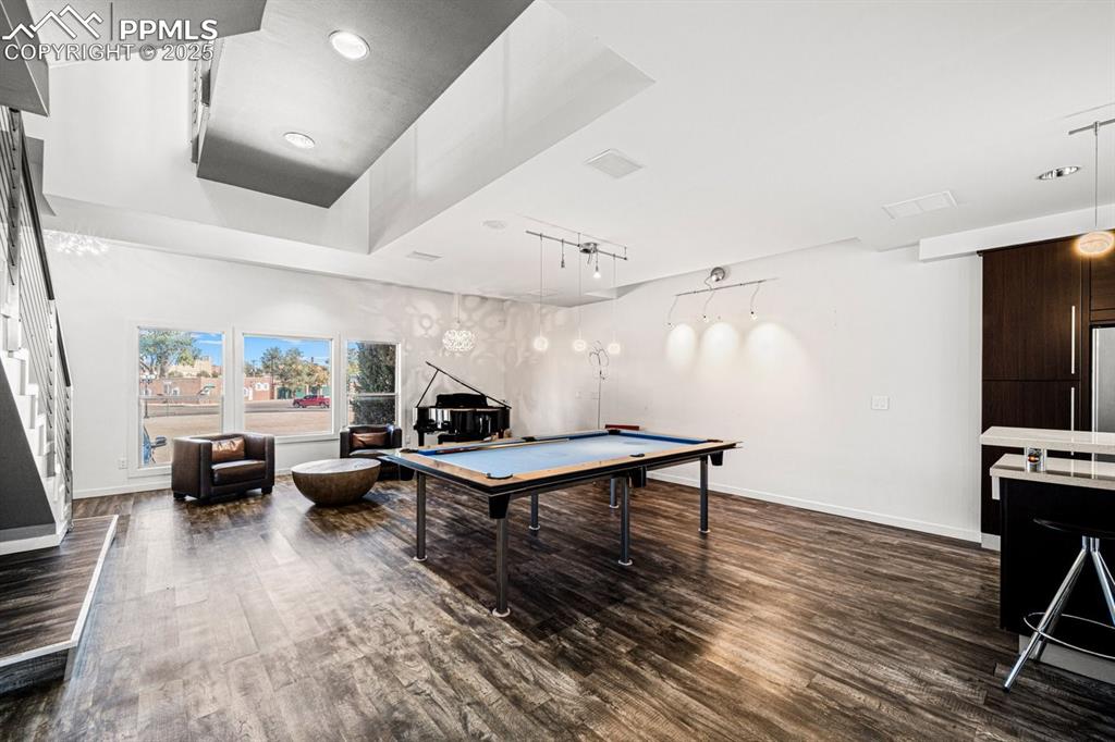 Image 13 of 41: Recreation room featuring billiards table, dark wood finished floors, a tra
