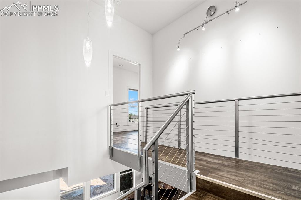 Image 16 of 41: Staircase with wood finished floors