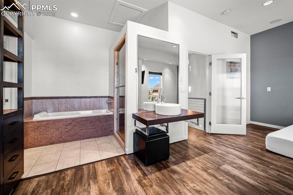 Image 20 of 41: Bathroom featuring a bath, vanity, a shower stall, recessed lighting, and d