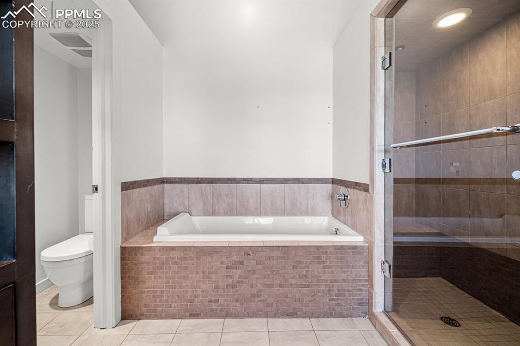 Image 21 of 41: Full bath featuring a bath, tile patterned floors, a stall shower, and rece