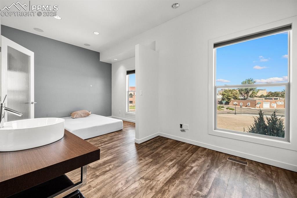 Image 22 of 41: Bedroom with recessed lighting and dark wood-style floors